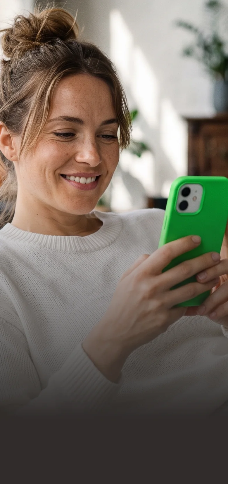 Woman relaxing on a sofa, paying with a glowing green phone